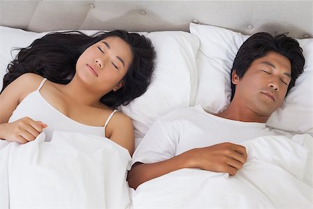 simsearch:400-07483522,k - Happy couple lying in bed asleep at home in bedroom Stock Photo - Budget Royalty-Free & Subscription, Code: 400-07483064