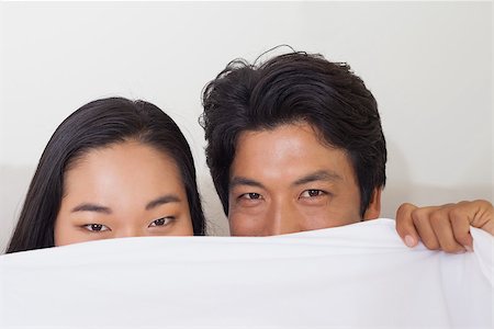 simsearch:400-07483522,k - Happy couple holding duvet over face at home in bedroom Stock Photo - Budget Royalty-Free & Subscription, Code: 400-07483066