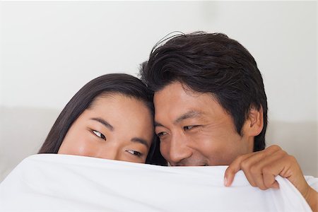 simsearch:400-07483522,k - Happy couple holding duvet over face at home in bedroom Stock Photo - Budget Royalty-Free & Subscription, Code: 400-07483068