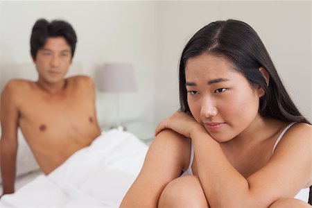 simsearch:400-07483522,k - Boyfriend looking at girlfriend sitting on end of bed at home in bedroom Stock Photo - Budget Royalty-Free & Subscription, Code: 400-07483075