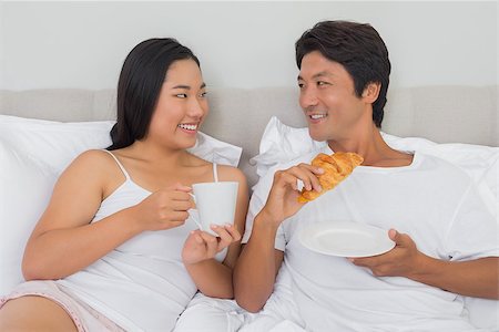 simsearch:400-07483522,k - Happy couple having breakfast in bed at home in bedroom Stock Photo - Budget Royalty-Free & Subscription, Code: 400-07483204