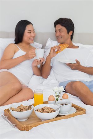 simsearch:400-07483522,k - Happy couple having breakfast in bed at home in bedroom Stock Photo - Budget Royalty-Free & Subscription, Code: 400-07483205