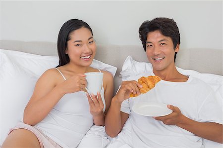 simsearch:400-07483522,k - Happy couple having breakfast in bed at home in bedroom Stock Photo - Budget Royalty-Free & Subscription, Code: 400-07483203