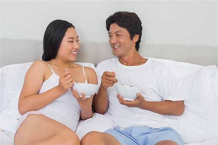 simsearch:400-07483522,k - Happy couple having breakfast in bed at home in bedroom Stock Photo - Budget Royalty-Free & Subscription, Code: 400-07483210