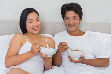 simsearch:400-07483522,k - Happy couple having breakfast in bed at home in bedroom Stock Photo - Budget Royalty-Free & Subscription, Code: 400-07483211