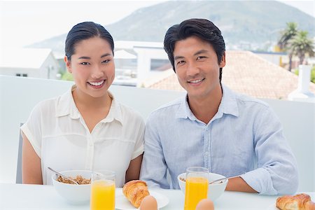 simsearch:400-07483384,k - Smiling couple having breakfast together outside on a balcony Stock Photo - Budget Royalty-Free & Subscription, Code: 400-07483314