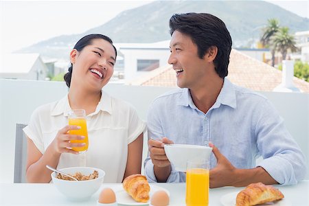 simsearch:400-07483384,k - Smiling couple having breakfast together outside on a balcony Stock Photo - Budget Royalty-Free & Subscription, Code: 400-07483315