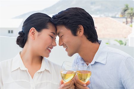 simsearch:400-07483384,k - Happy couple having white wine outside on a balcony Stock Photo - Budget Royalty-Free & Subscription, Code: 400-07483338