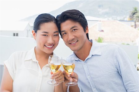 simsearch:400-07483384,k - Happy couple having white wine outside on a balcony Stock Photo - Budget Royalty-Free & Subscription, Code: 400-07483339