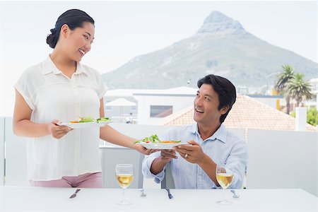 simsearch:400-07483384,k - Woman serving a meal for her boyfriend outside on a balcony Stock Photo - Budget Royalty-Free & Subscription, Code: 400-07483344