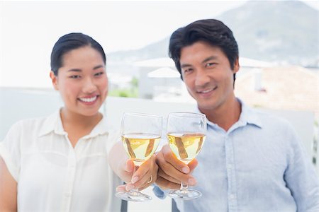 simsearch:400-07483384,k - Happy couple having white wine outside on a balcony Stock Photo - Budget Royalty-Free & Subscription, Code: 400-07483342