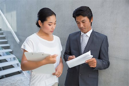 simsearch:400-07475963,k - Estate agent showing lease to customer and smiling outside a house Stock Photo - Budget Royalty-Free & Subscription, Code: 400-07483426