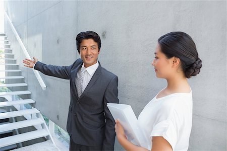 simsearch:400-07475963,k - Estate agent showing stairs to customer and smiling outside a house Stock Photo - Budget Royalty-Free & Subscription, Code: 400-07483429