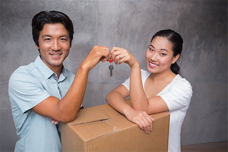 simsearch:400-07928013,k - Happy couple holding house key and leaning on moving box in their new home Fotografie stock - Microstock e Abbonamento, Codice: 400-07483497