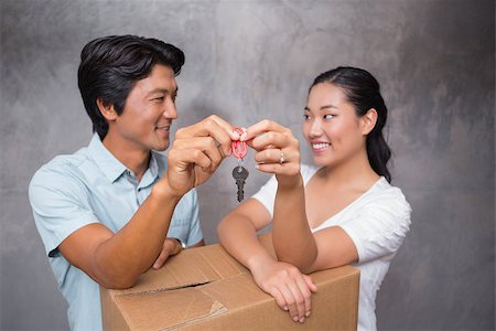 simsearch:400-07928013,k - Happy couple holding house key and leaning on moving box in their new home Fotografie stock - Microstock e Abbonamento, Codice: 400-07483498