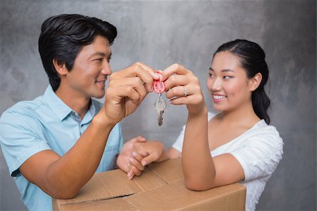 simsearch:400-07928013,k - Happy couple holding house key and leaning on moving box in their new home Fotografie stock - Microstock e Abbonamento, Codice: 400-07483499