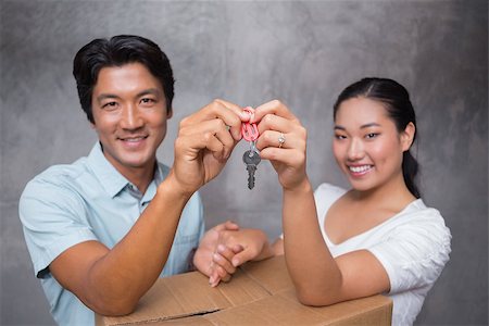 simsearch:400-07928013,k - Happy couple holding house key and leaning on moving box in their new home Fotografie stock - Microstock e Abbonamento, Codice: 400-07483500