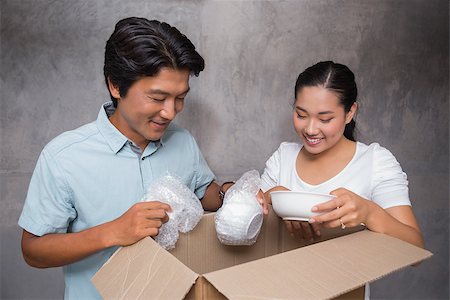 simsearch:400-07928013,k - Happy couple unpacking moving boxes in their new home Fotografie stock - Microstock e Abbonamento, Codice: 400-07483502