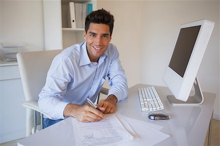 signing contract on computer - Casual businessman sitting at desk writing in his office Stock Photo - Budget Royalty-Free & Subscription, Code: 400-07483675