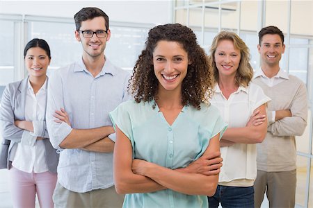 simsearch:400-07186359,k - Casual business team smiling at camera with arms crossed in the office Photographie de stock - Aubaine LD & Abonnement, Code: 400-07483878