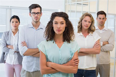 simsearch:400-07186359,k - Casual business team frowning at camera with arms crossed in the office Stock Photo - Budget Royalty-Free & Subscription, Code: 400-07483879