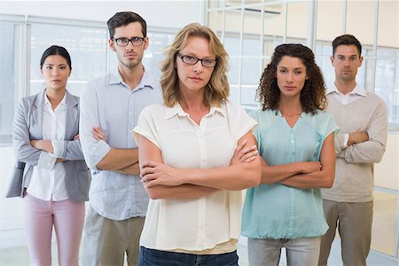 simsearch:400-07186359,k - Casual business team frowning at camera with arms crossed in the office Stock Photo - Budget Royalty-Free & Subscription, Code: 400-07483886