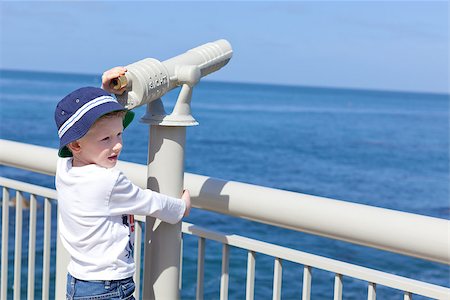 simsearch:400-05677109,k - little positive boy using seaside binoculars and enjoying the view Stock Photo - Budget Royalty-Free & Subscription, Code: 400-07506023