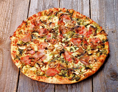 simsearch:400-07481067,k - Freshly Baked Pizza with Edible Mushrooms, Bacon, Cheese and Spinach Sauce isolated on Rustic Wooden background Stock Photo - Budget Royalty-Free & Subscription, Code: 400-07506048