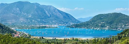 simsearch:400-05244057,k - Many sailing vessels in bay. Hazy summer Lefkada coast panorama (Nydri, Greece, Ionian Sea). Stockbilder - Microstock & Abonnement, Bildnummer: 400-07506118