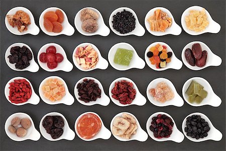 simsearch:400-07510855,k - Large dried fruit selection in white bowls over slate background. Photographie de stock - Aubaine LD & Abonnement, Code: 400-07506922