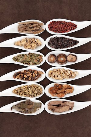 Yang herbs used in chinese herbal medicine in white china dishes over lokta paper background. Stock Photo - Budget Royalty-Free & Subscription, Code: 400-07506984