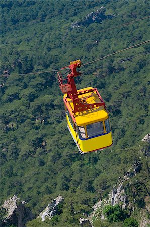 Bright yellow cable railway carriage hangs over the precipice. This cable car takes passengers from a station near Alupka to the main area in Ai-Petri (Crimea). Stock Photo - Budget Royalty-Free & Subscription, Code: 400-07507231