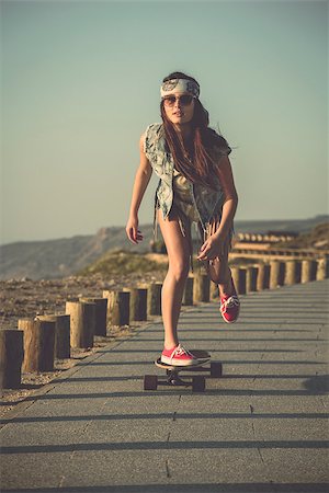 simsearch:400-07507525,k - Young woman down the street with a skateboard Stock Photo - Budget Royalty-Free & Subscription, Code: 400-07507517