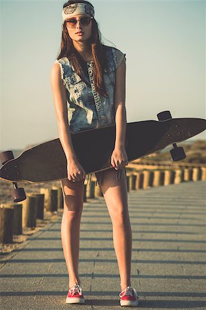 Beautiful and fashion young woman posing with a skateboard Stock Photo - Budget Royalty-Free & Subscription, Code: 400-07507520