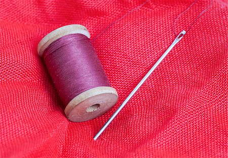 skein of thread and needle on the red cloth Stock Photo - Budget Royalty-Free & Subscription, Code: 400-07508563