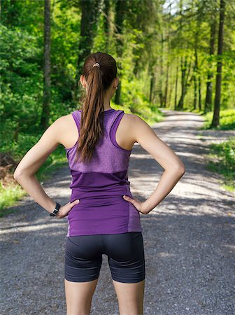 simsearch:400-07682342,k - Photo of a young woman looking down the gravel path through a forest before she starts her exercise. Stock Photo - Budget Royalty-Free & Subscription, Code: 400-07509636