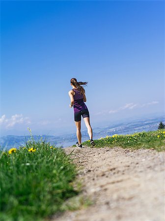 simsearch:400-07682342,k - Photo of a young woman jogging and exercising on a country path.  Lake in the distance. Stock Photo - Budget Royalty-Free & Subscription, Code: 400-07509633