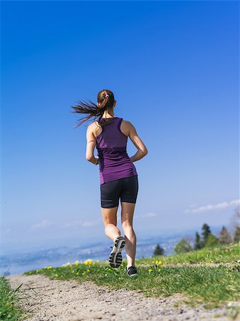 simsearch:400-07682342,k - Photo of a young woman jogging and exercising on a country path.  Lake in the distance. Stock Photo - Budget Royalty-Free & Subscription, Code: 400-07509640