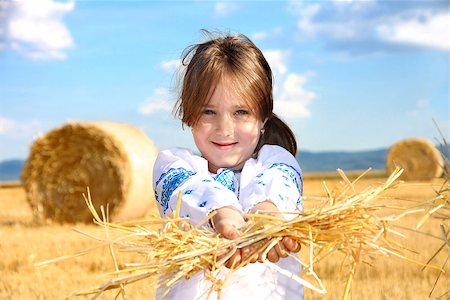 small rural girl on harvest field with straw bales Stock Photo - Budget Royalty-Free & Subscription, Code: 400-07509732