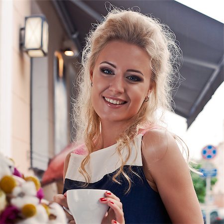 a beautiful young blond girl in summer dress at the table in pavement cafe is smiling for the camera Stock Photo - Budget Royalty-Free & Subscription, Code: 400-07509918