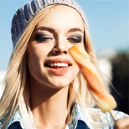 simsearch:400-07509968,k - Smiling blond girl with plump sexy lips and smokey eye make up looks at sweet delicious fruit ice cream Stock Photo - Budget Royalty-Free & Subscription, Code: 400-07509956