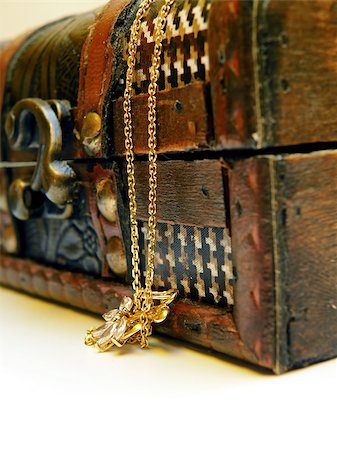 Detail of old treasure chest with gold chain. Isolated over white background. Stock Photo - Budget Royalty-Free & Subscription, Code: 400-07500019