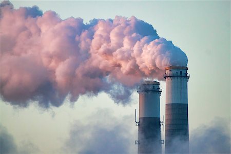 smoke chimney - Lit by the Central Florida sunrise, smoke pours from the stacks of a coal-fired electrical power generation plant. This close-up image shows the scrubbers at the top of the stacks against a blue sky. Stock Photo - Budget Royalty-Free & Subscription, Code: 400-07502522