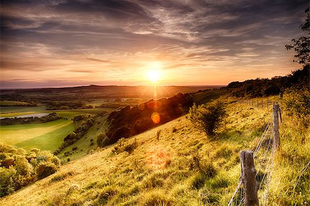 Hill fence landscape with evening sunset Foto de stock - Royalty-Free Super Valor e Assinatura, Número: 400-07502698