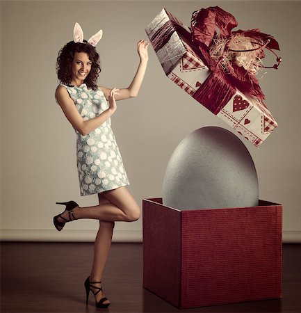 simsearch:400-06557487,k - very cute young woman in spring ligh blue dress, with bunny ears, near easter big box with egg inside , grunge color Stock Photo - Budget Royalty-Free & Subscription, Code: 400-07502774