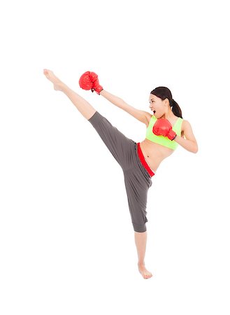 pretty female boxer  is kicking and punching Stock Photo - Budget Royalty-Free & Subscription, Code: 400-07503424