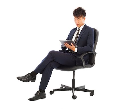 simsearch:400-07514126,k - businessman using tablet pc on the chair Fotografie stock - Microstock e Abbonamento, Codice: 400-07514124