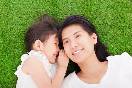 mother and daughter whispering gossip on the grass Stock Photo - Budget Royalty-Free & Subscription, Code: 400-07514179