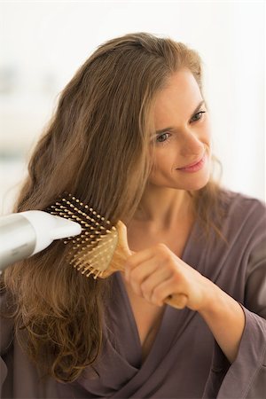 Young woman blow drying hair Stock Photo - Budget Royalty-Free & Subscription, Code: 400-07514402