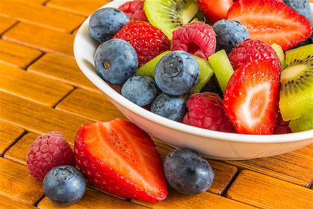 porridge and berries - Sweet berry of raspberries, strawberries and blueberries, some of in a small bowl and on wooden tray, healthy breakfast Stock Photo - Budget Royalty-Free & Subscription, Code: 400-07514838